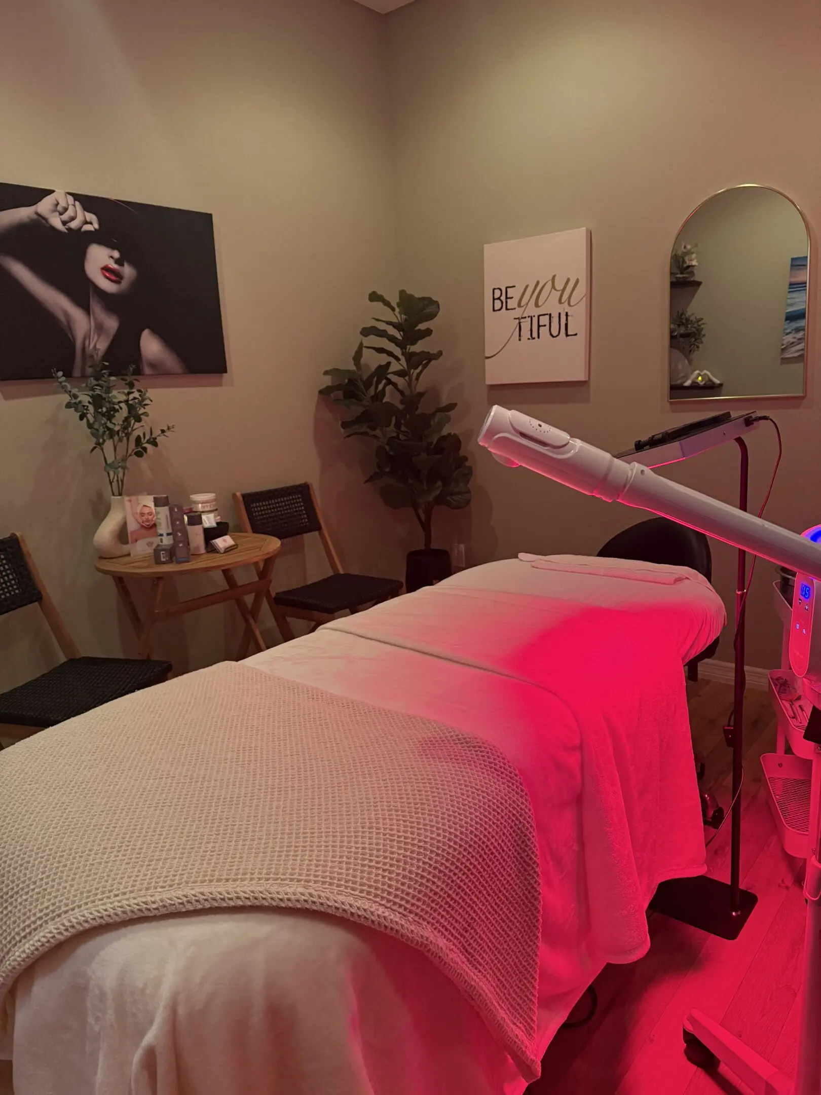 A room with a microphone and pink lights