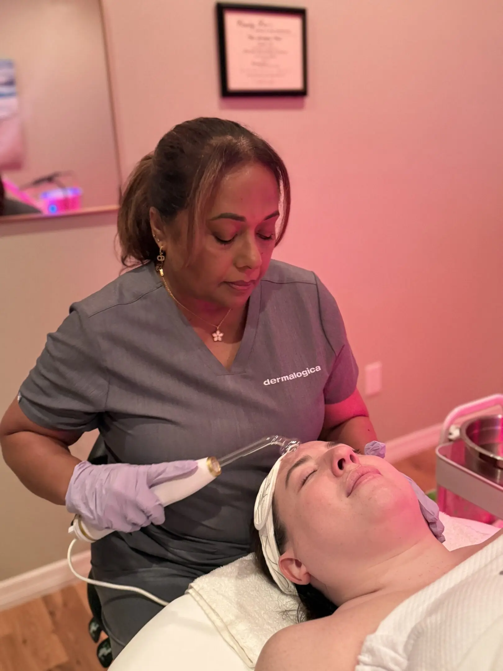 A woman is getting her face waxed at the salon.