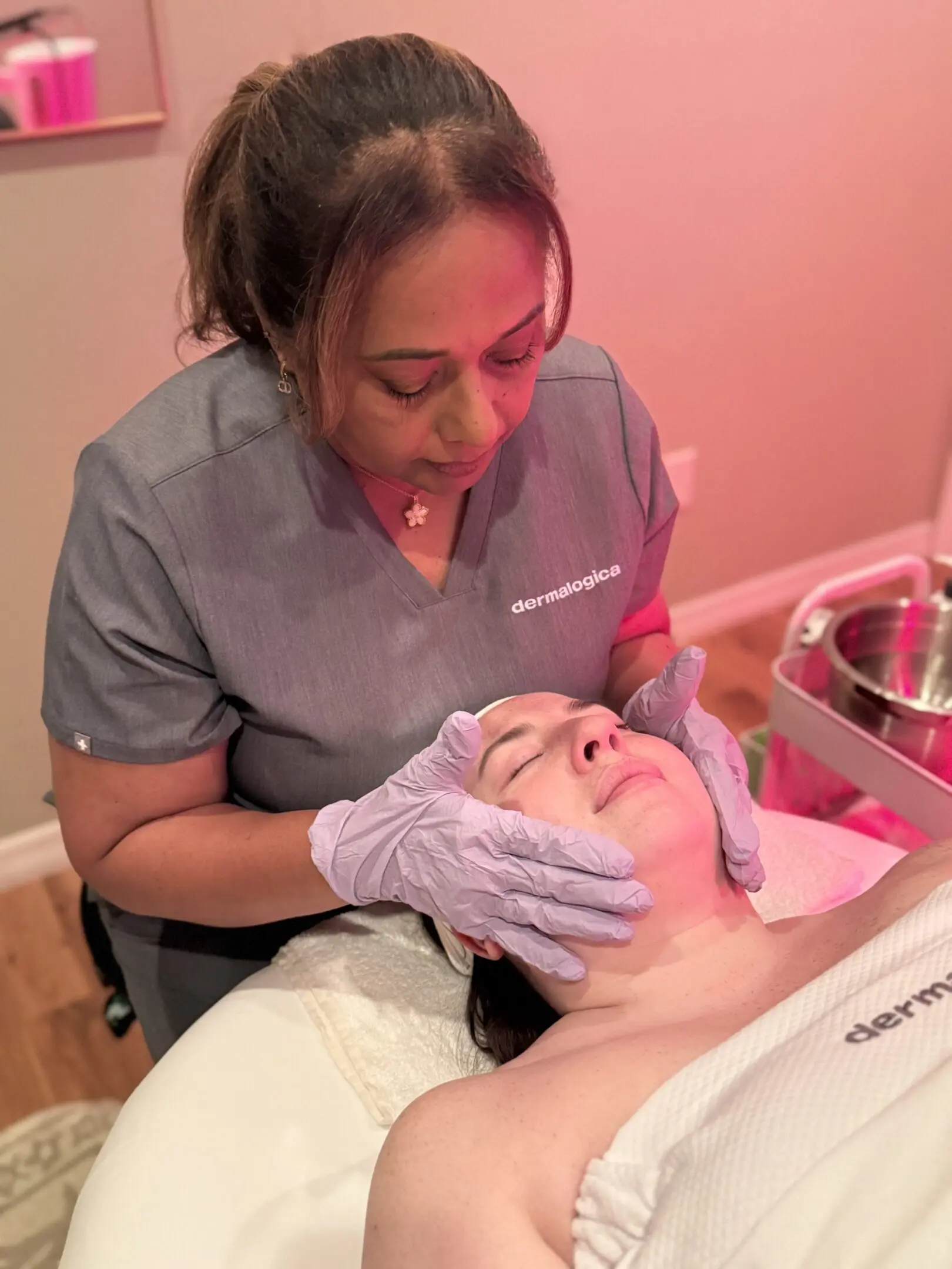 A woman is getting her face waxed